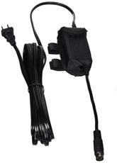 A black power cord with a plug attached, coiled neatly on a white surface.